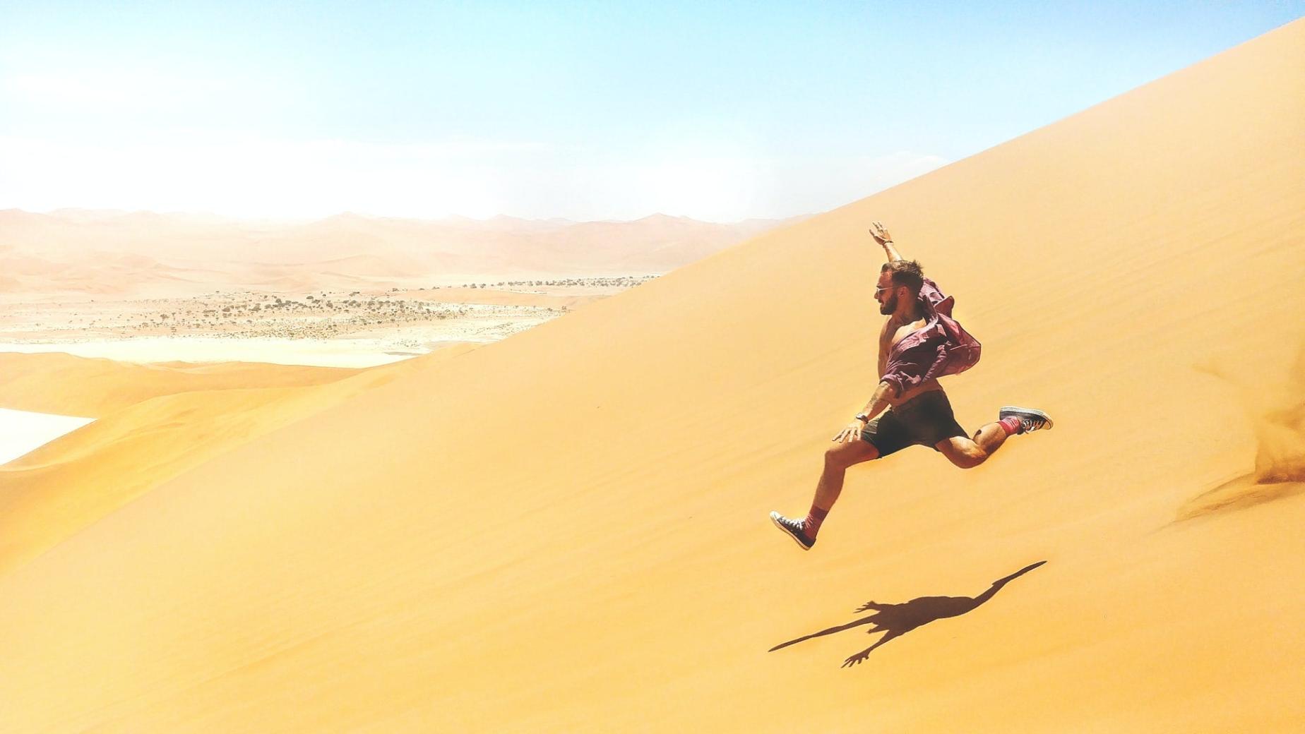 Person running over a sand dune: How To Motivate Yourself