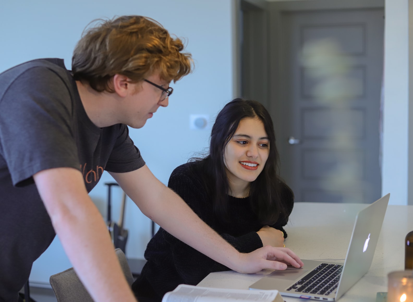 Two people discussing work over a laptop 