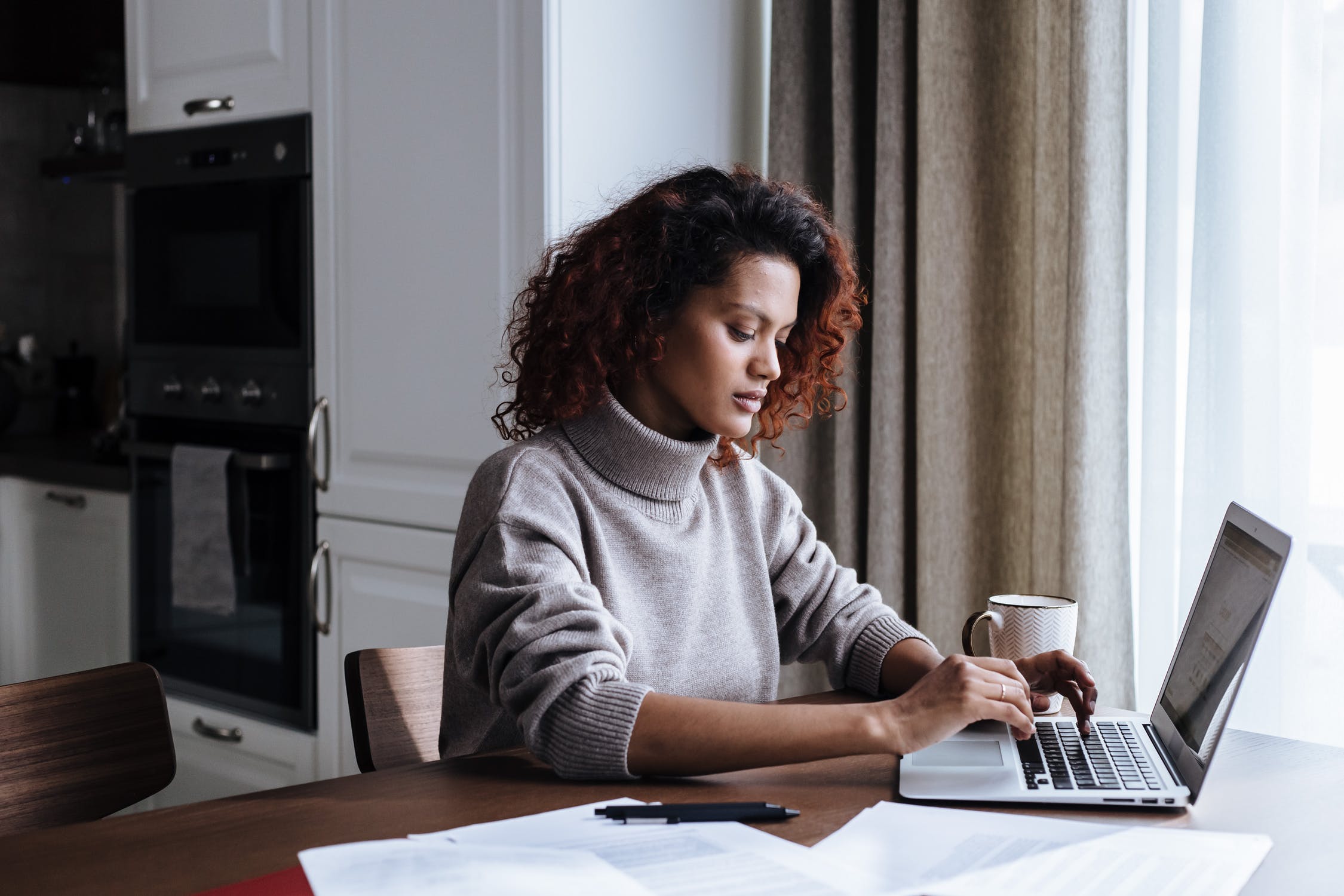 Woman working on a laptop from home