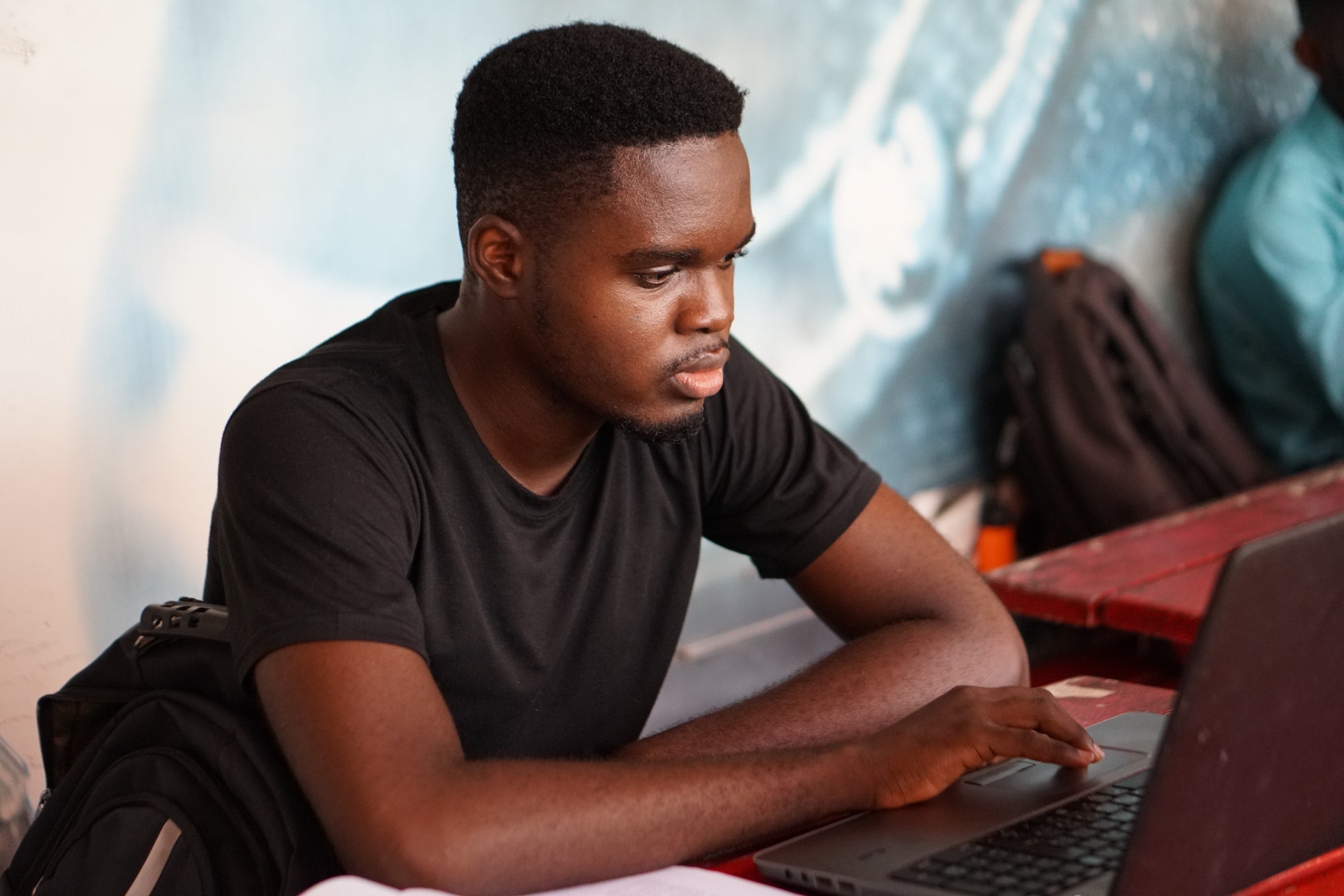 Man working on a laptop at a coffee shop  